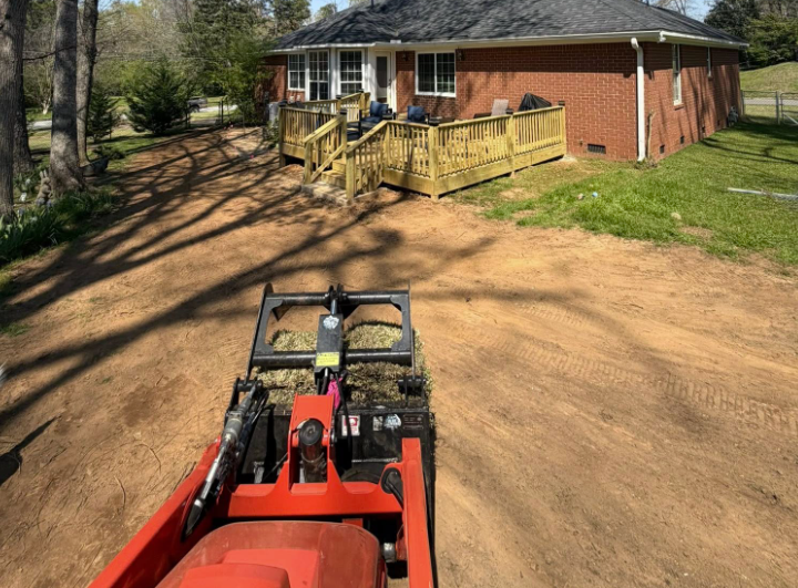 Skid steer grading and site prep at a brick home